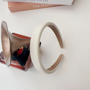 Close-up of off-white woven sponge headband with elegant vintage texture for women