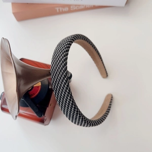 Detail of checkered padded headband with non-slip suede lining on a vintage desk