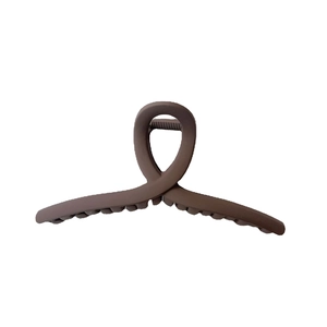 Matte dark brown oversized hair claw clip in a minimalist cross design for long hair
