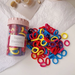 Detail of colorful high elasticity hair bands in a clear storage jar for little girls