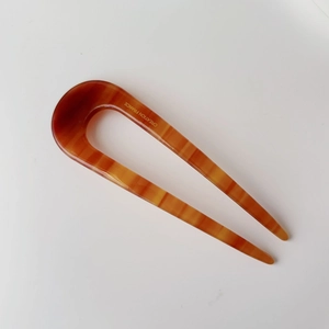 Elegant U-shaped acetate hair fork with amber tortoiseshell pattern for bun styling
