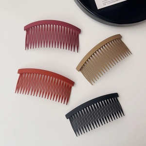 Detail of four matte non-slip hair side combs in red, khaki, and black colors