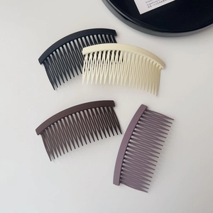 Detailed view of 4-piece non-slip matte hair side combs in assorted neutral colors