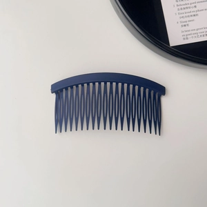 Detail of navy blue hair side comb with 23 teeth and matte anti-slip finish for styling