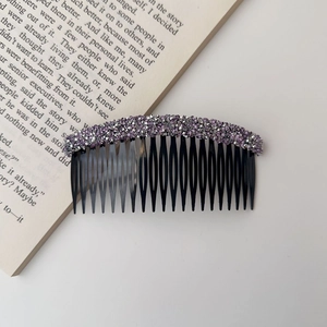 Detailed macro view of hair comb featuring sparkling purple and silver rhinestones