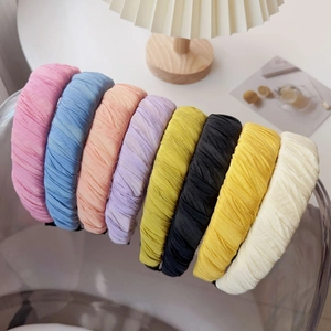 Detailed view of assorted pleated fabric headbands in candy colors and textured finish