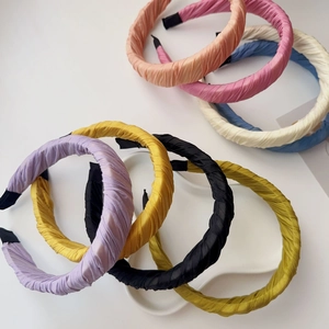 Detailed close-up showing wrinkled fabric texture of various candy colored wide headbands