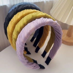 Close-up of pleated chiffon headband set in multiple colors with soft fabric texture