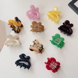 Detailed macro view of small resin butterfly hair clips in various vibrant colors