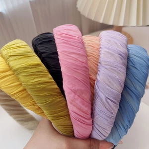 Detail of pleated fabric headbands in assorted macaron candy colors for women