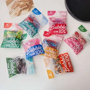 Flat lay of colorful 25mm elastic hair bands in transparent 100-piece packaging bags