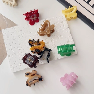Close-up of colorful butterfly and rectangular hair clips in various vibrant colors