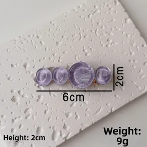 Detail view of purple water ripple hair clip with dimensions 6cm by 2cm and weight 9g