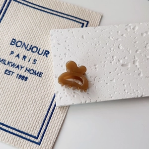Detail of amber resin mini hair claw with Barrette la France engraving on stone