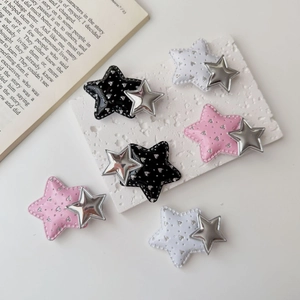 Detailed view of y2k star hair clips in pink, black, and white with silver star accents
