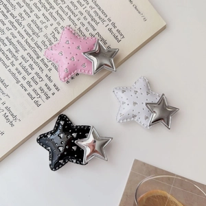 Detailed view of Y2K star hair clips in pink, white, and black with metallic finish