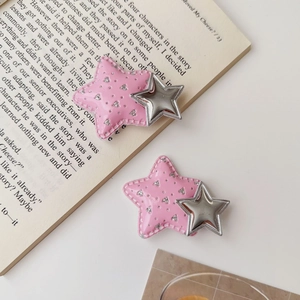 Close-up of pink Y2K star hair clips with silver glitter and faux leather stitching details