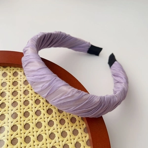 Detail of light purple pleated chiffon headband with soft fabric folds and protective ends