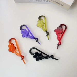 Floral resin banana hair clips in five colors with a minimalist retro twisted design