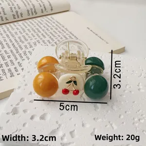 Detail shot of cherry pattern acrylic hair claw clip with size measurements 5cm x 3.2cm