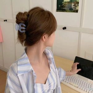 Light blue frosted pumpkin hair claw clip shown on a model for a chic high ponytail