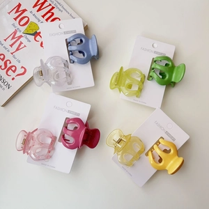 Flat lay of colorful jelly pumpkin hair claws in 8 shades on white display cards
