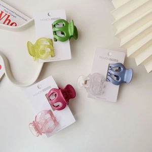 Close-up of colorful matte and jelly pumpkin hair claws on fashion display cards