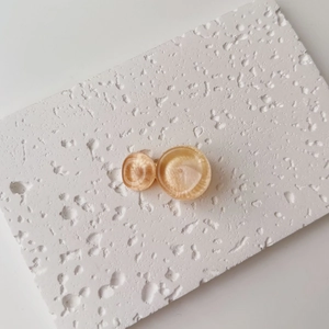 Detail of amber water ripple resin hair clip with dual circle geometric design