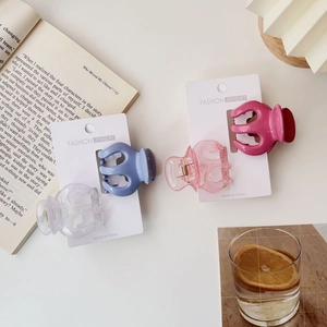 Set of four translucent candy-colored pumpkin hair claws with fashion packaging