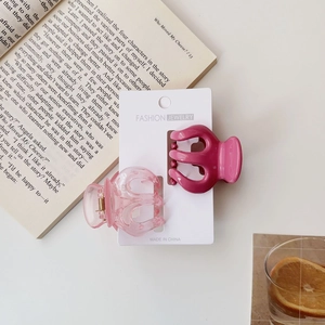Detail of candy color pumpkin hair claws on display card with pink and rose red finishes