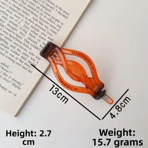 Detailed view of an amber tortoise hair claw clip with dimensions 13cm length