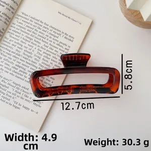 Detailed size view of a 12.7cm amber acrylic hair claw clip for elegant updo hairstyles