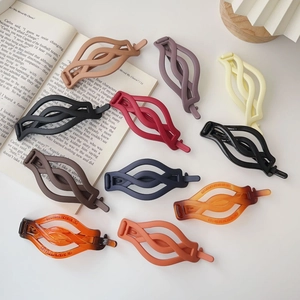 Various matte finish twisted claw clips in multiple colors for elegant hair styling