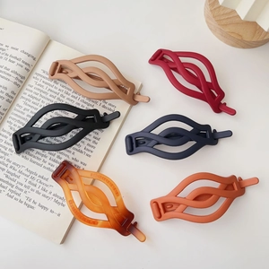 Detailed set of six matte wavy hair clips in diverse colors like navy, amber, and khaki