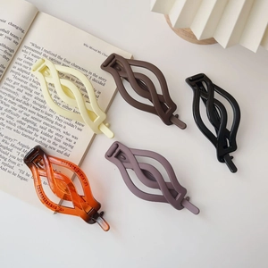 Five matte twist hair clips in various colors including cream and amber for women's hair styling