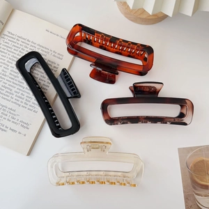 Detail view of large acrylic rectangular hair claw clips in various colors