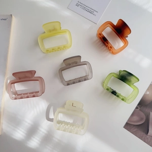 Set of 6 matte Morandi jelly colored rectangle hair claw clips displayed in natural sunlight