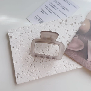 Close-up of translucent frosted hair claw clip with rectangular hollow design