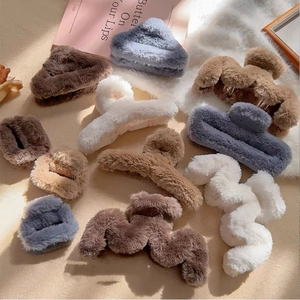 Detail of plush faux fur hair claws in various autumn colors and different shapes