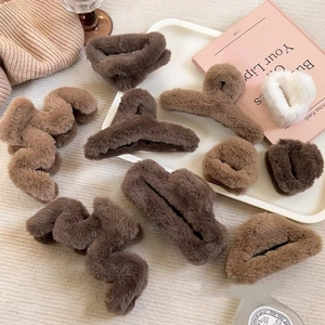 Detail of plush faux fur hair claw clips and matching scrunchies in warm latte colors