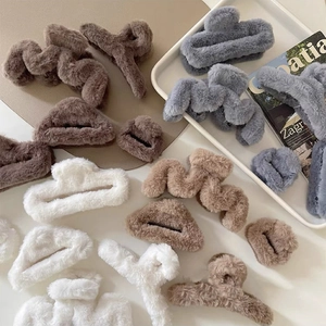 Detailed view of plush shark hair claws in assorted shapes like wave and heart styles