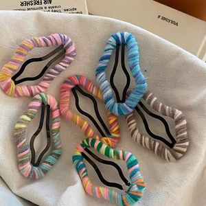 Set of six colorful knitted wool hair clips featuring soft multi-color braided patterns