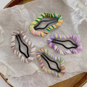 Set of four handmade knitted wave-shaped cloud hair clips in colorful yarn wrapping
