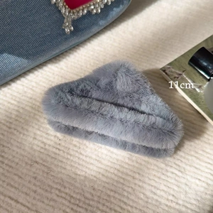 Detailed view of an 11cm large grey plush shark hair claw clip for thick hair styling