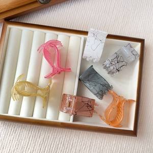 Detailed set of small matte hair clips in six colors with artistic marble texture detail