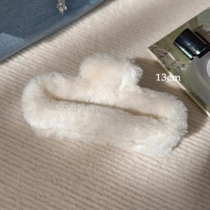 Detail of 13cm large plush hair claw clip in white, showing soft faux fur texture and size