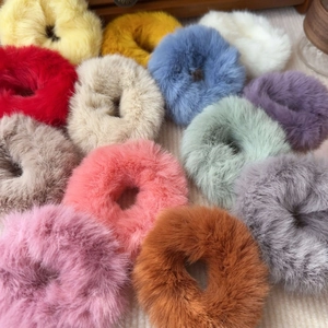 Close-up of colorful faux fur scrunchies showing soft texture and vibrant winter colors