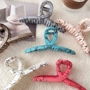 Detailed set of matte large shark hair clips with marble texture in six assorted colors