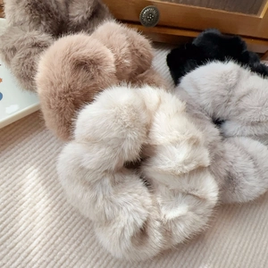 Macro shot of assorted faux mink fur scrunchies in neutral earth tones with soft texture