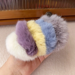 Set of five fluffy plush hair ties in white, purple, yellow, blue, and grey colors